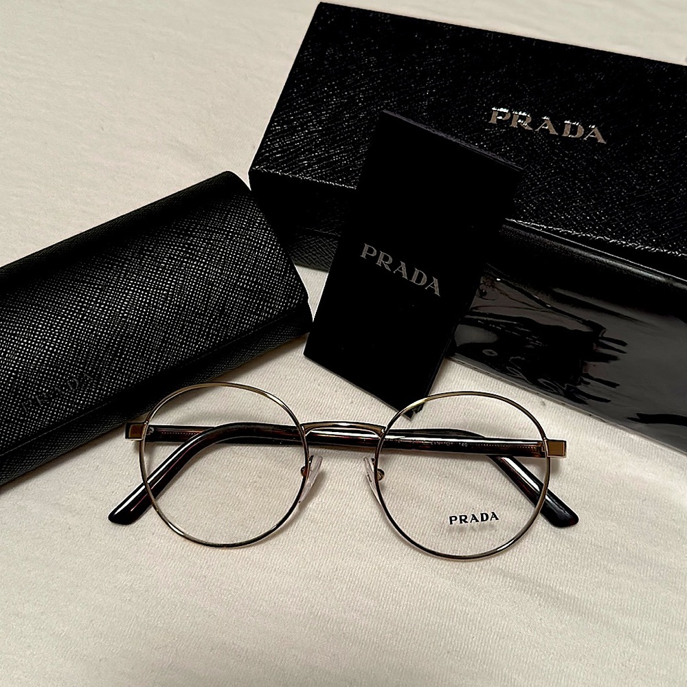 Prada VPR 52X eyeglasses. Shape-round. Unisex. Gold with tortoise temples